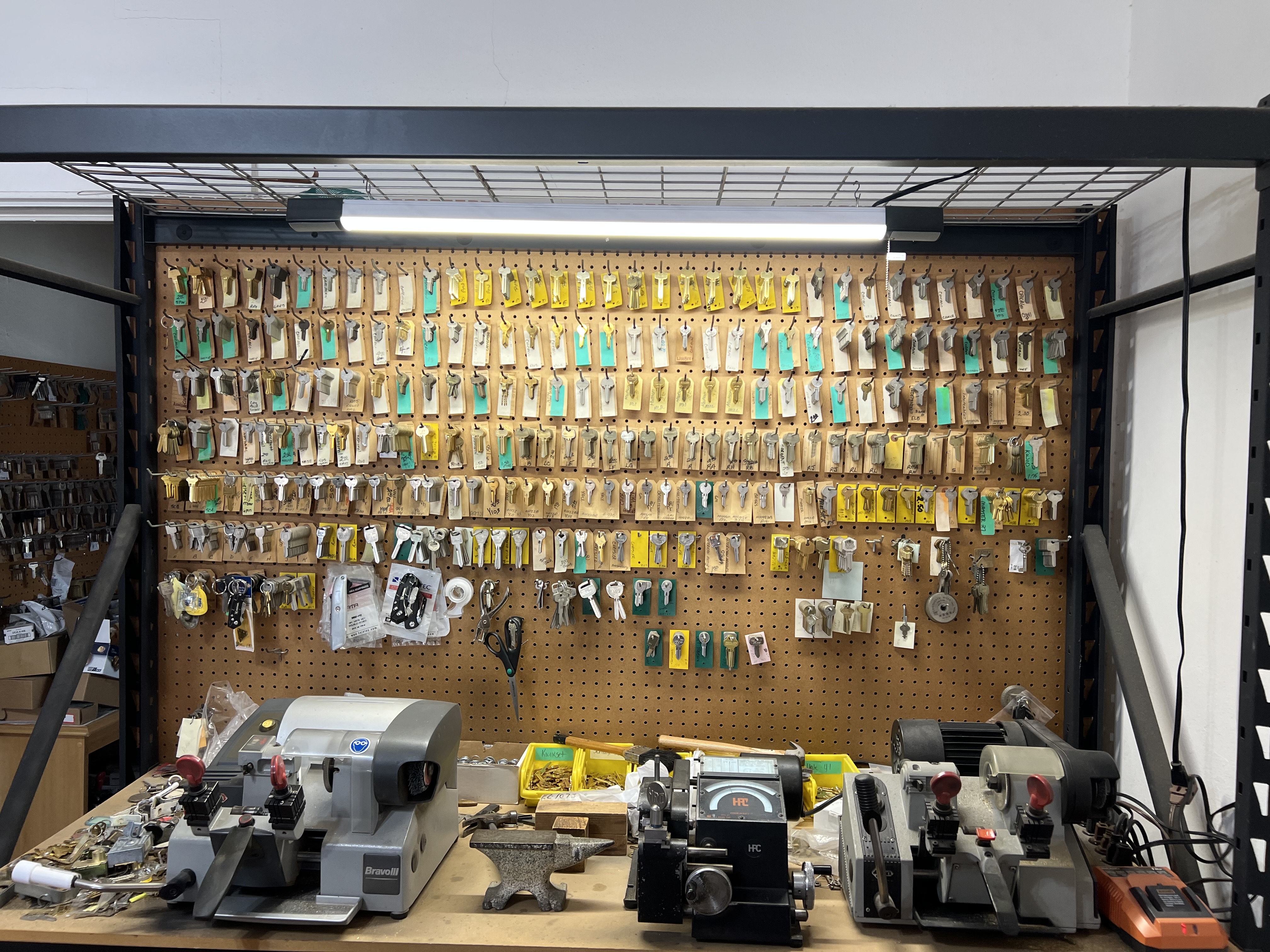 Key cutting machines and key wall at A-1 Locksmith Shop in Brownwood TX for commercial locksmith services